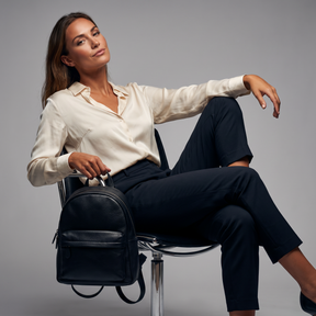 Modelo sentada con la mochila de piel genuina Alder